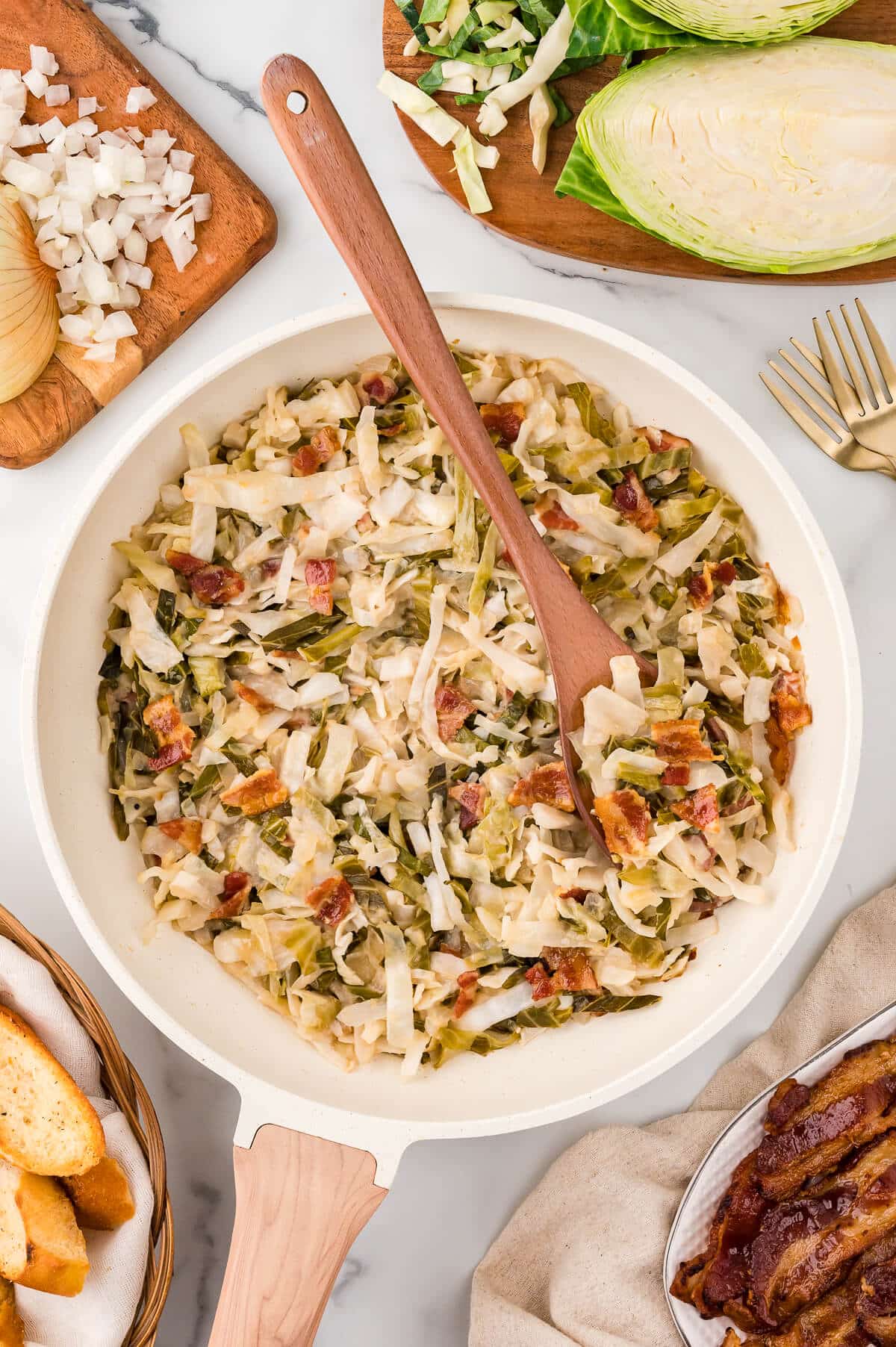 Sweet and sour cabbage in a pot with a wooden spoon.