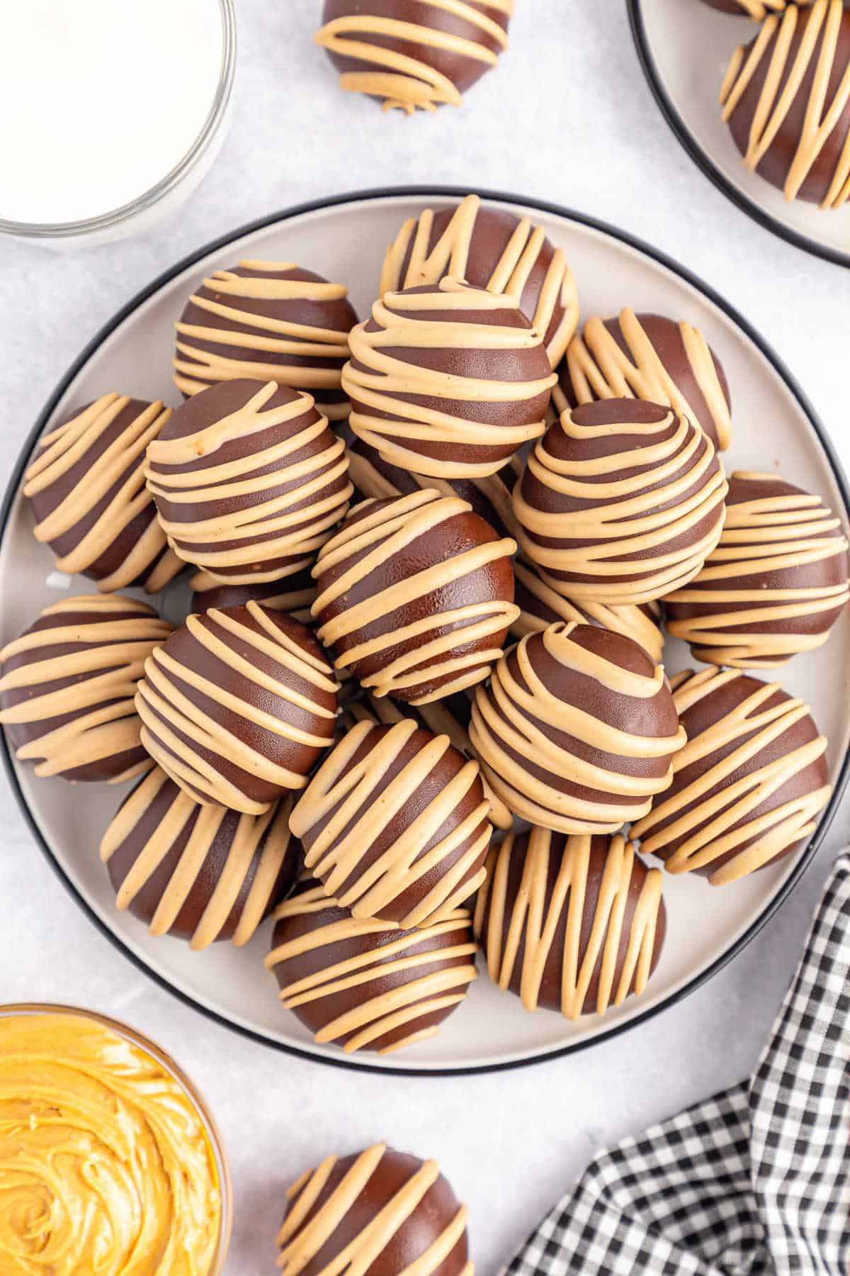 Chocolate covered peanut butter balls on a plate.