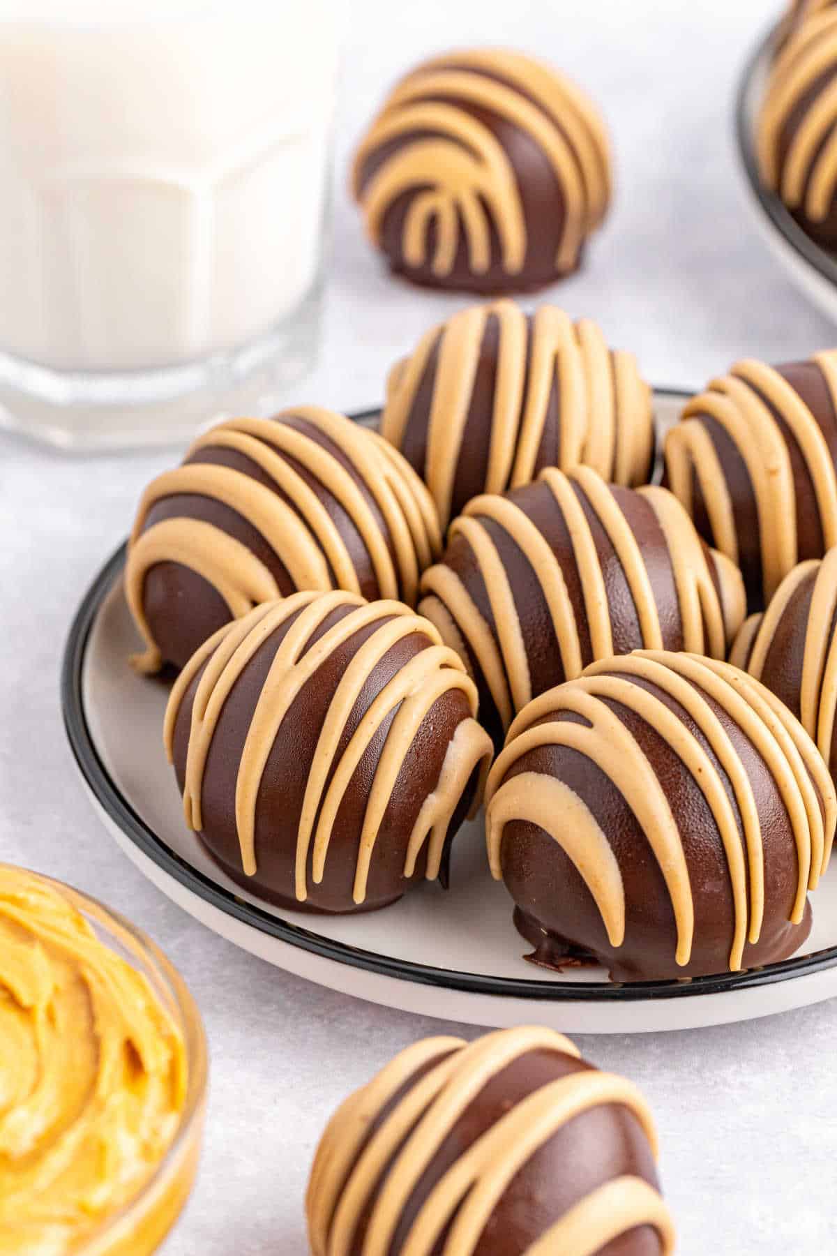 Chocolate covered peanut butter balls on a plate.