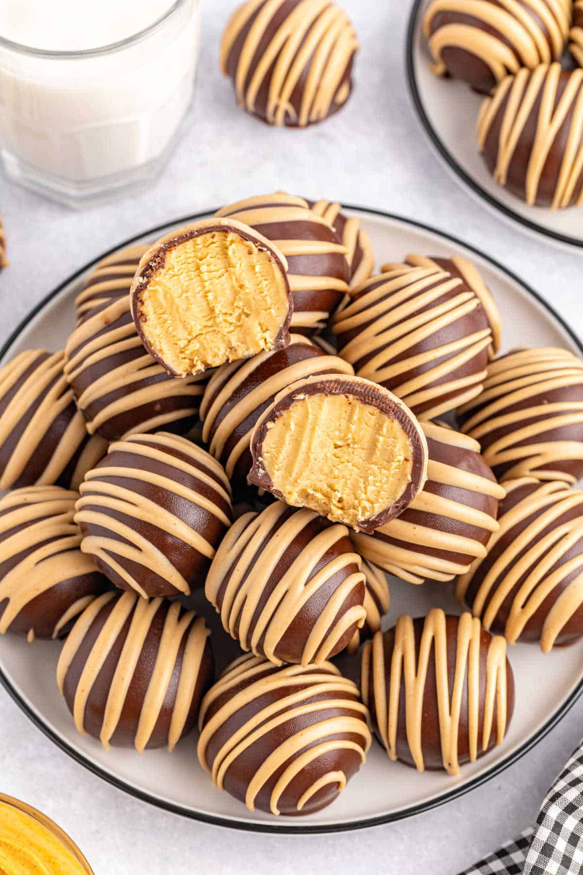 Chocolate covered peanut butter balls on a plate.