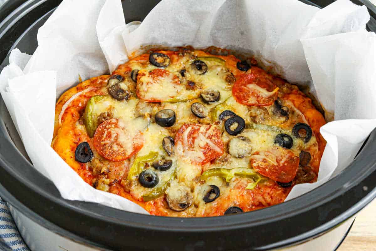 A supreme pizza in a Crockpot.