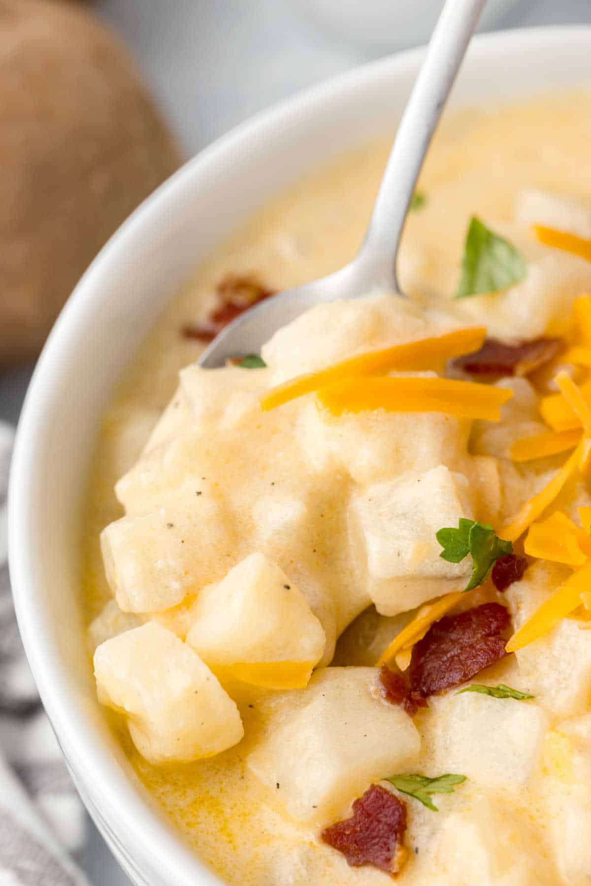 A bowl of hash brown potato soup.