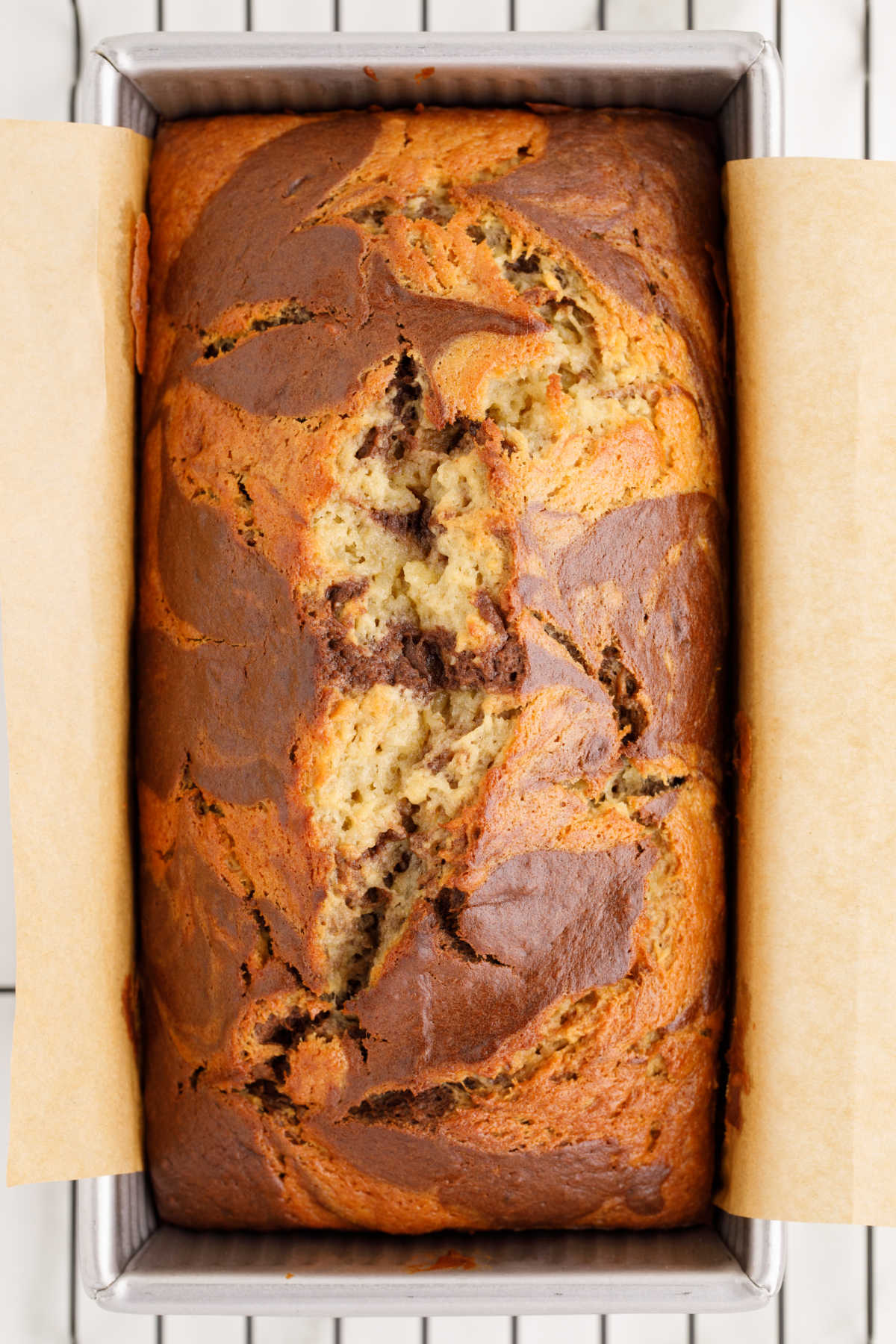 Marbled banana bread in a loaf pan.