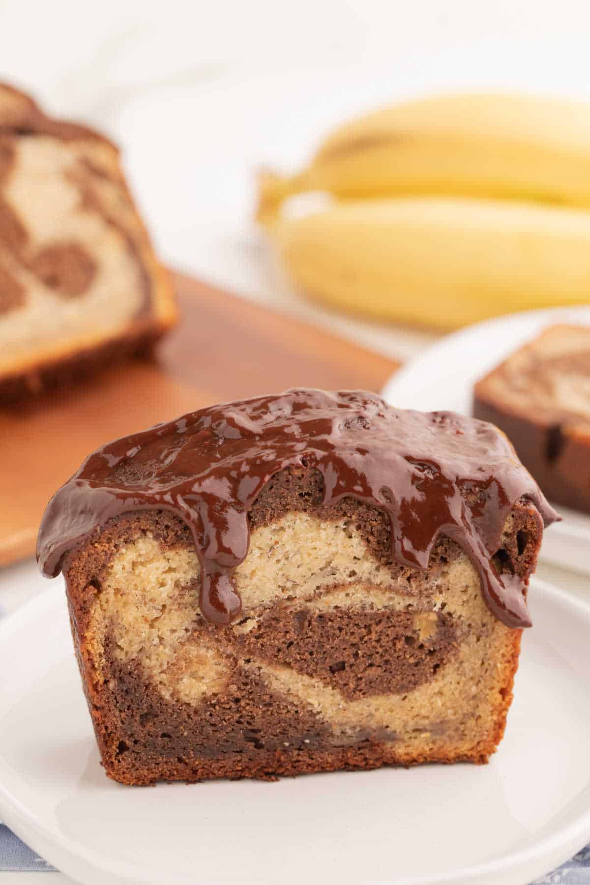 A slice of marbled banana bread on a plate.