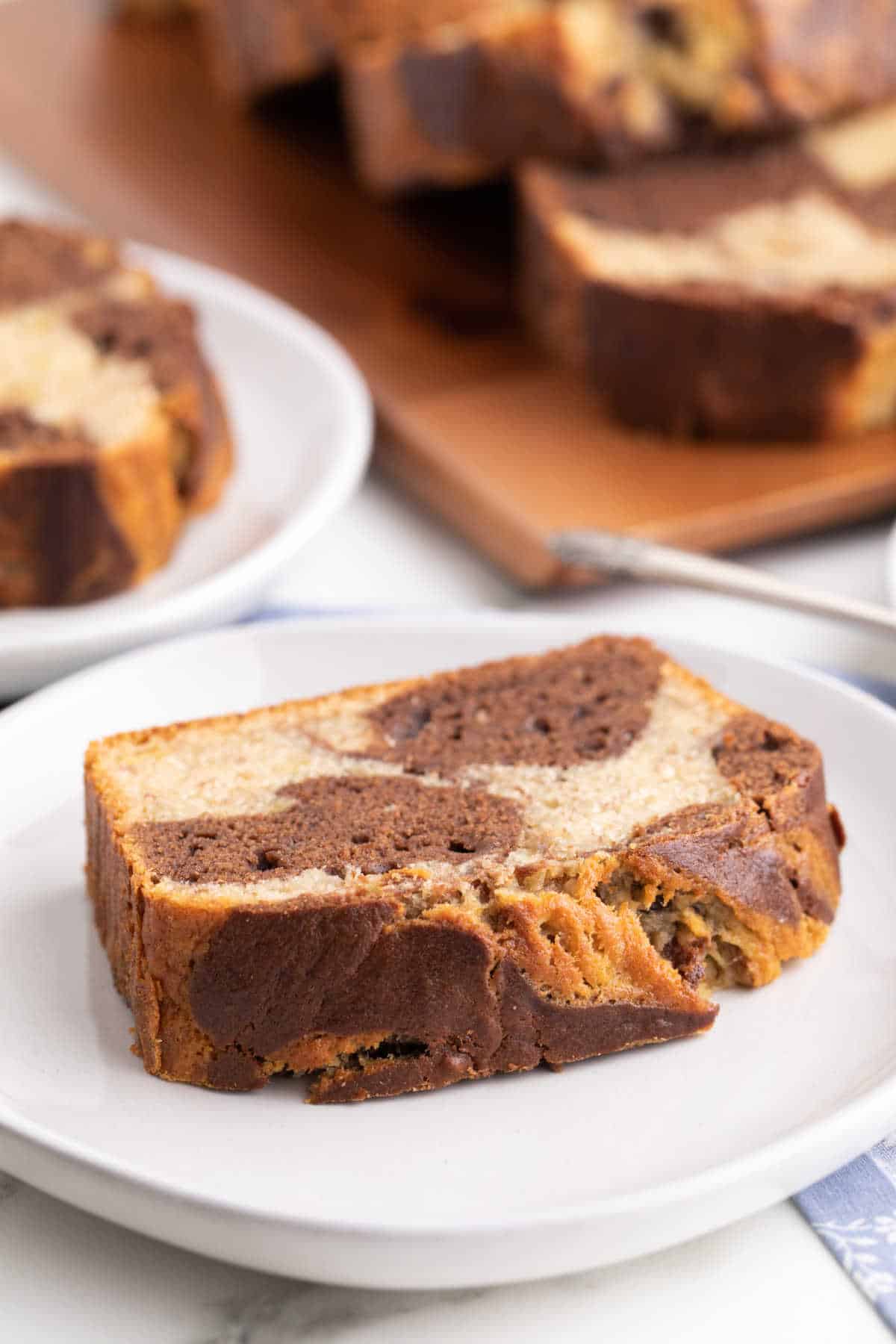A slice of marbled banana bread on a plate.