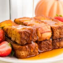 The recipe on a plate with maple syrup being drizzled on top.