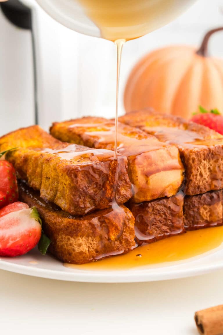 The recipe on a plate with maple syrup being drizzled on top.
