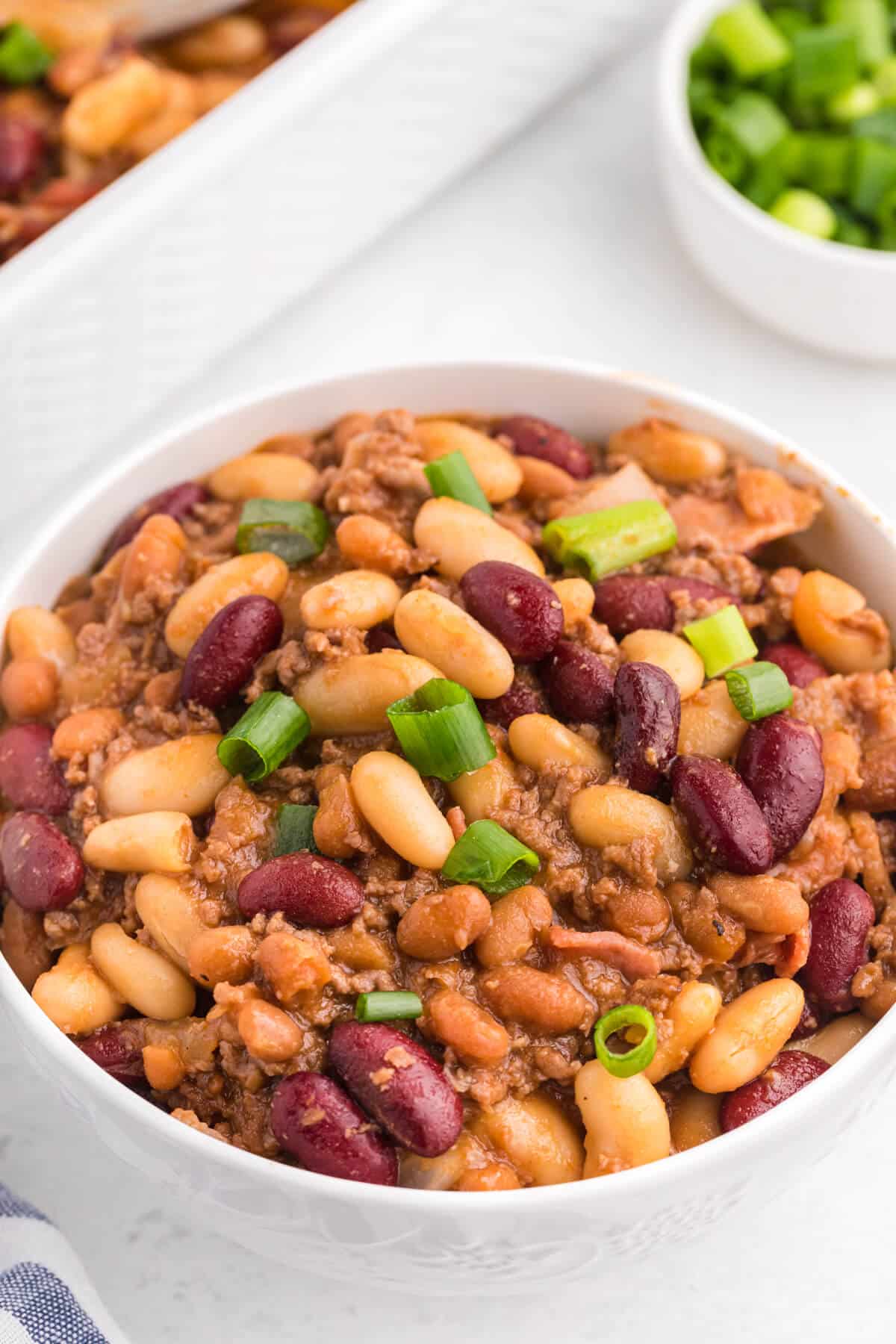 Baked bean casserole in a white bowl.