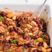 The casserole with a serving spoon.