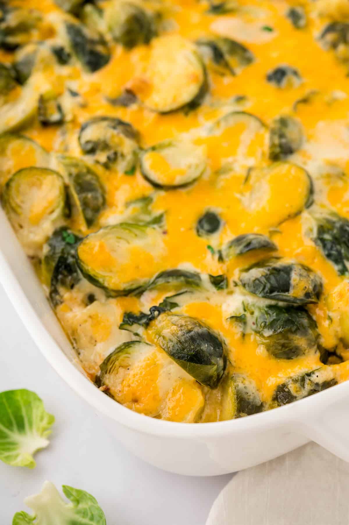 Cheesy brussel sprouts in a casserole dish.