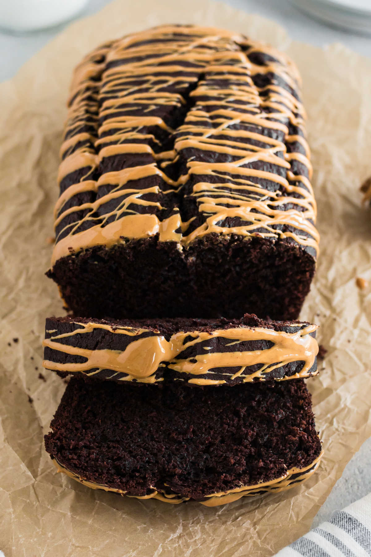 A loaf of chocolate peanut butter banana bread with slices cut.