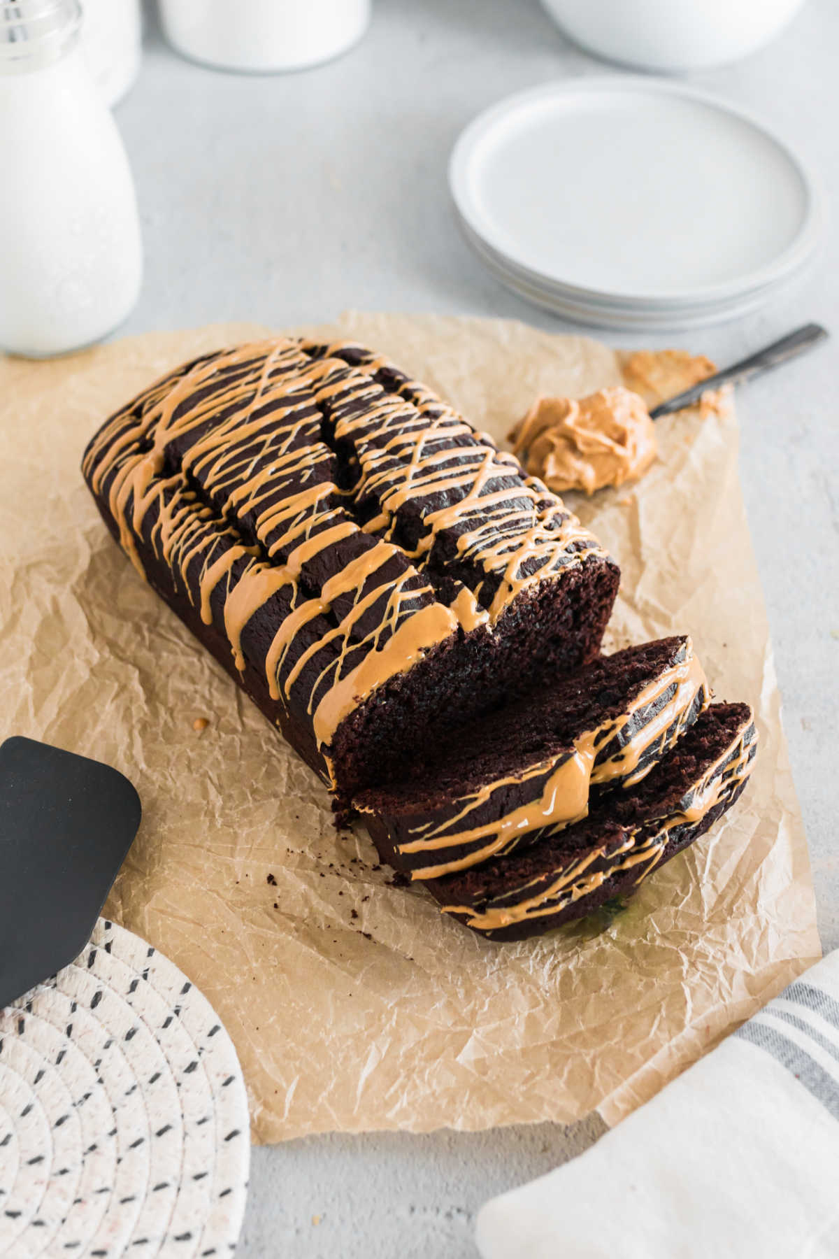 A loaf of chocolate peanut butter banana bread with slices cut.