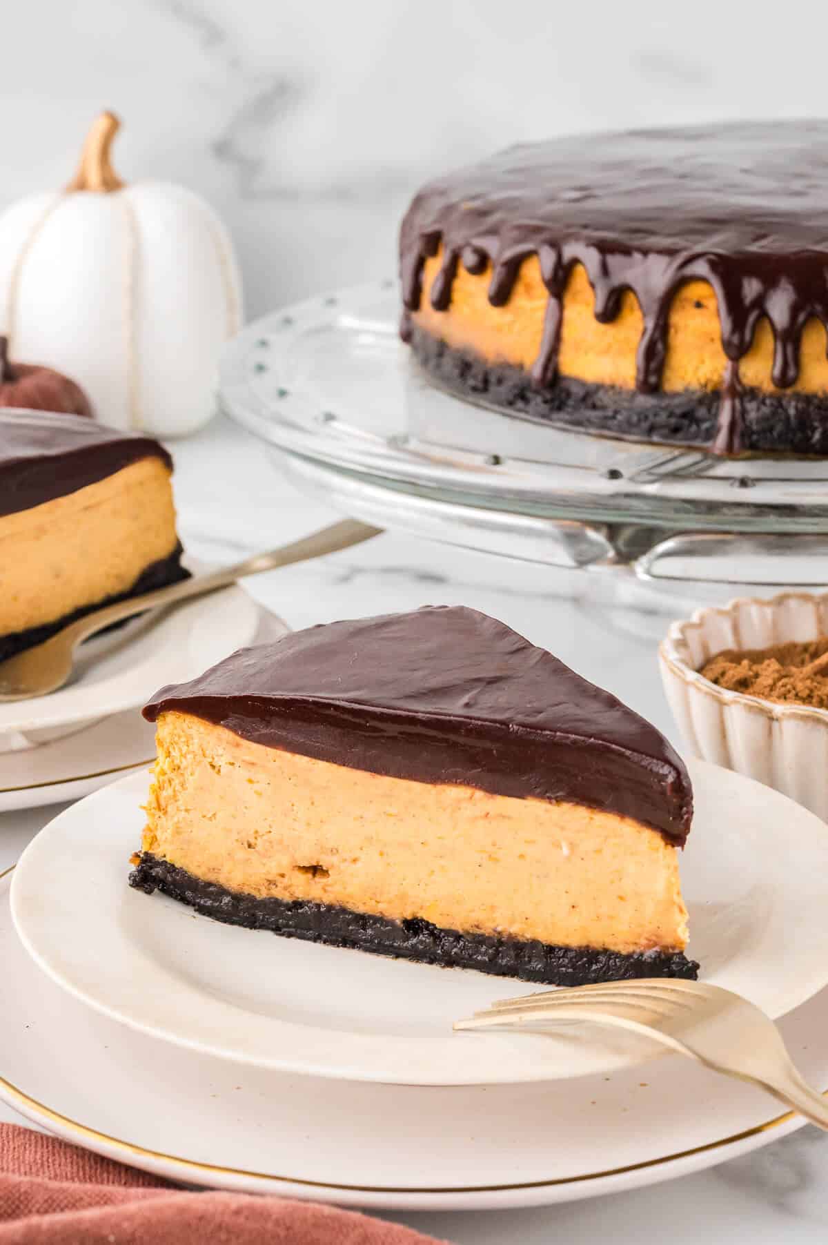 A slice of chocolate pumpkin cheesecake on a plate.