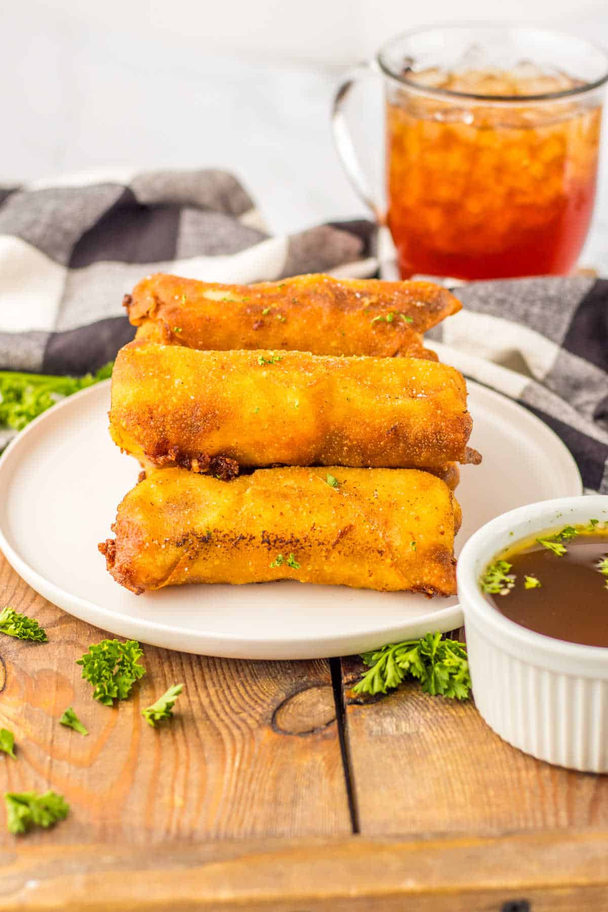 French dip egg rolls on a plate.