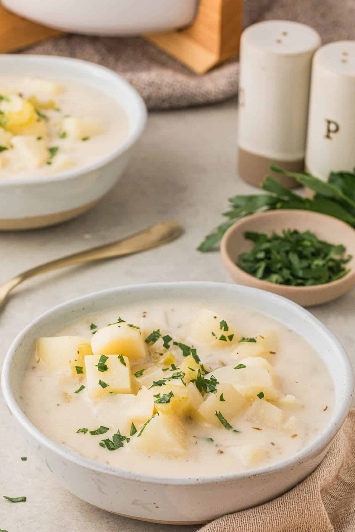 A white bowl of German Potato Soup.