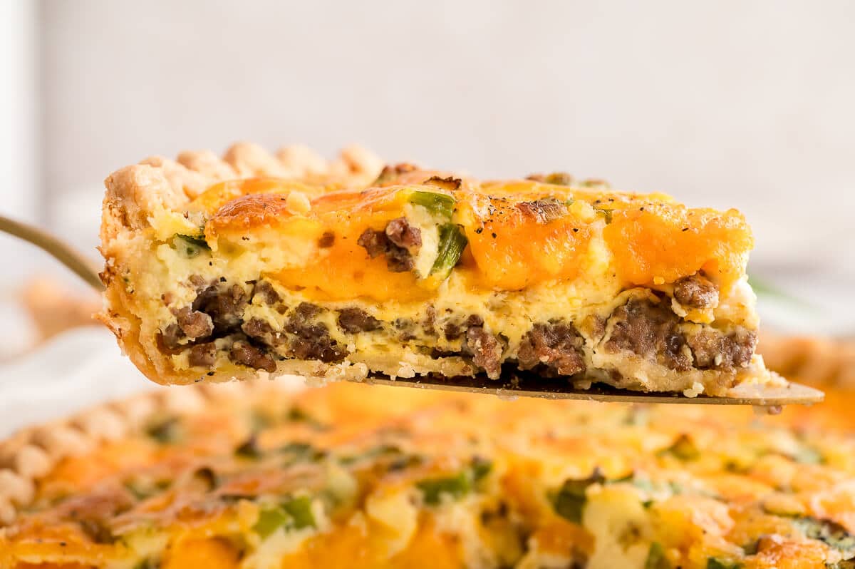 A slice of hamburger quiche on a spatula.