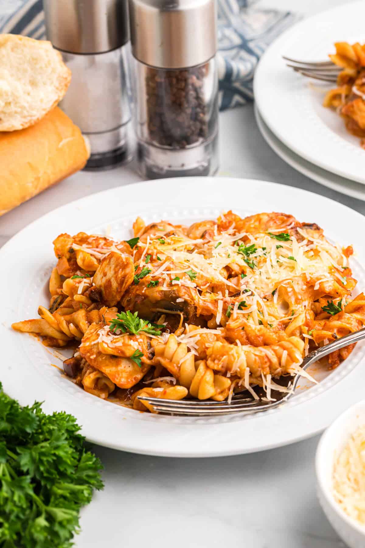 Baked chicken and tarragon pasta served on a plate.