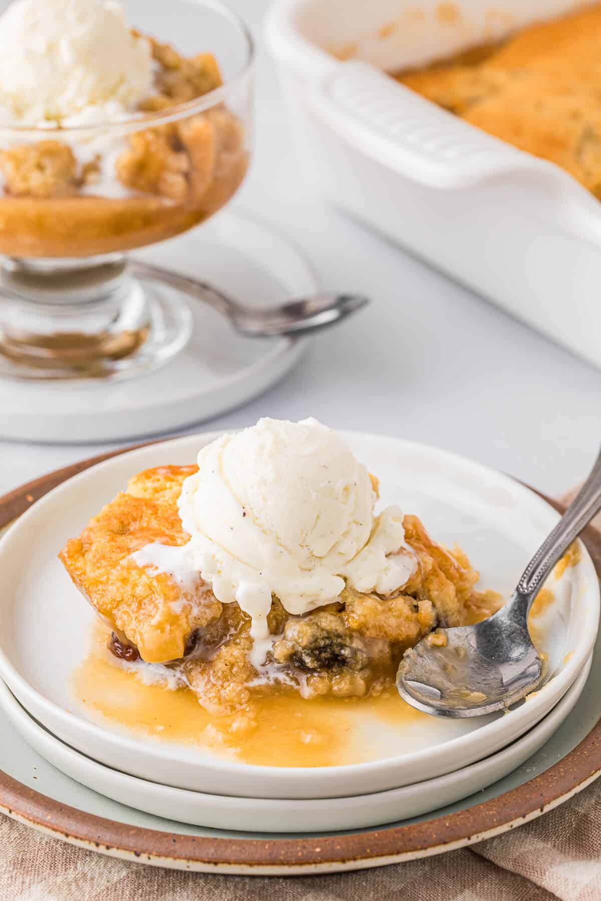 Radio pudding on a plate with vanilla ice cream.