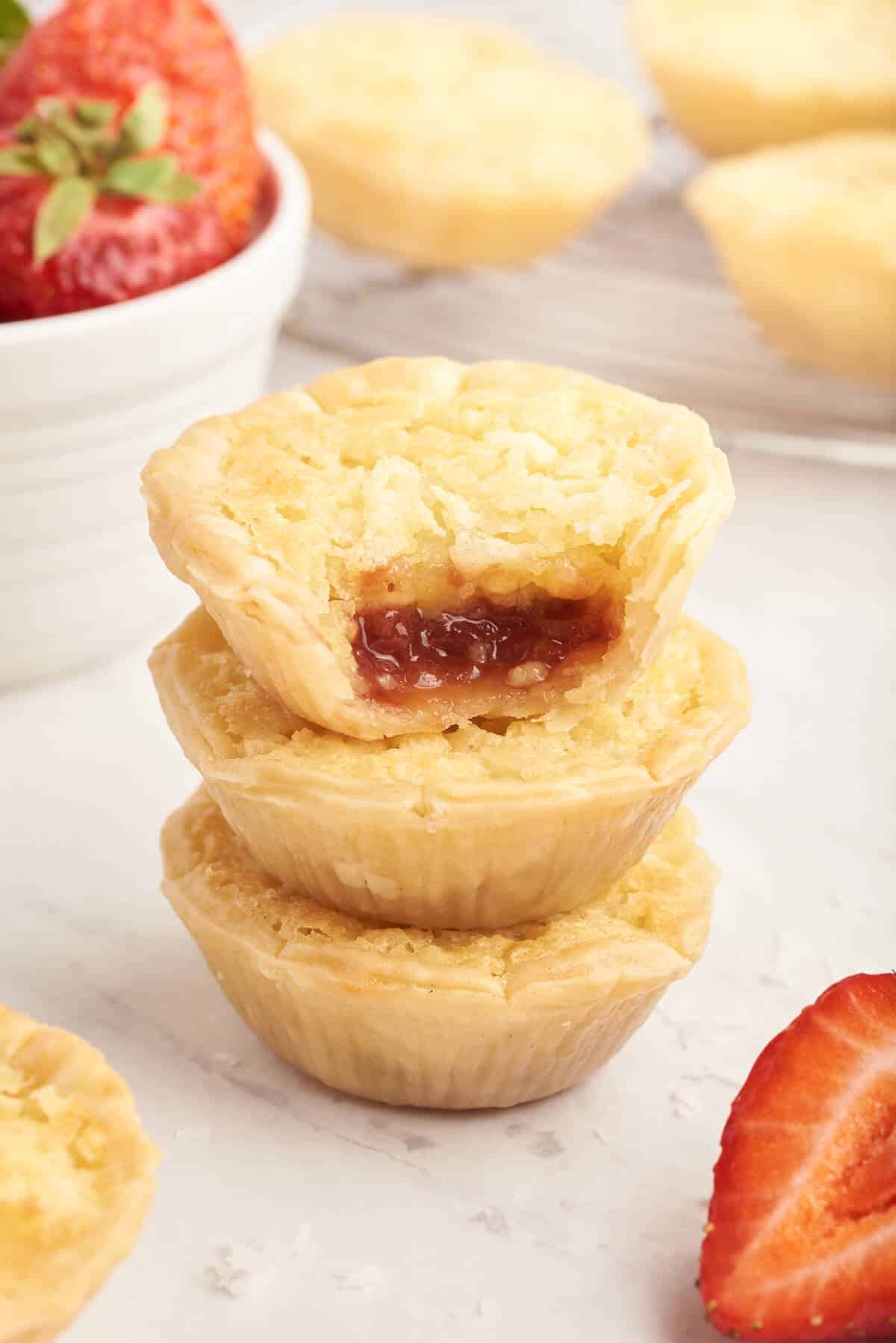 A stack of strawberry coconut tarts.