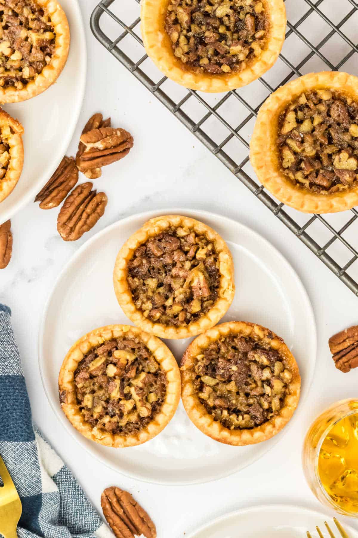 Pecan bourbon butter tarts on a plate.