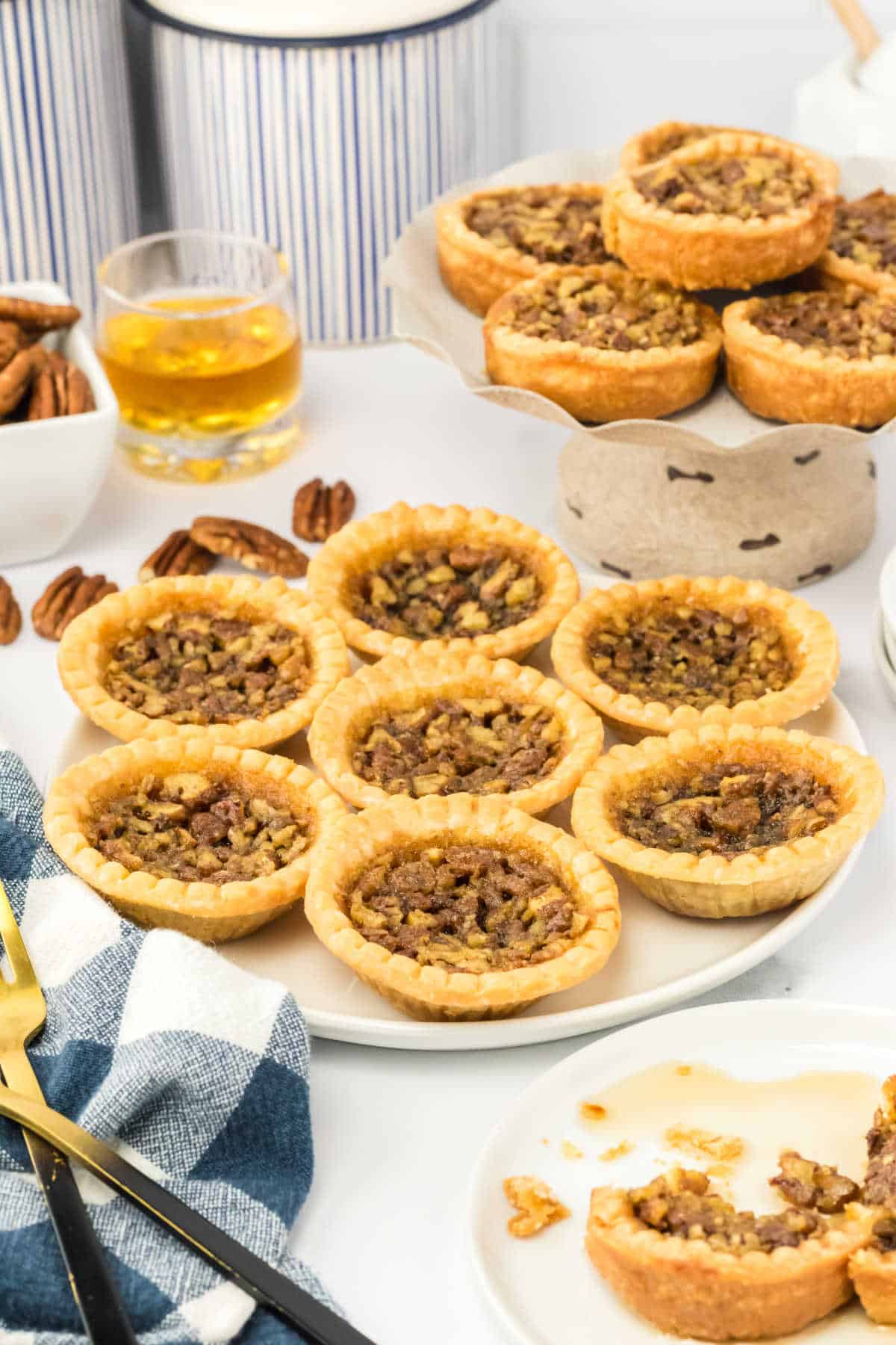 Pecan bourbon butter tarts on a plate.