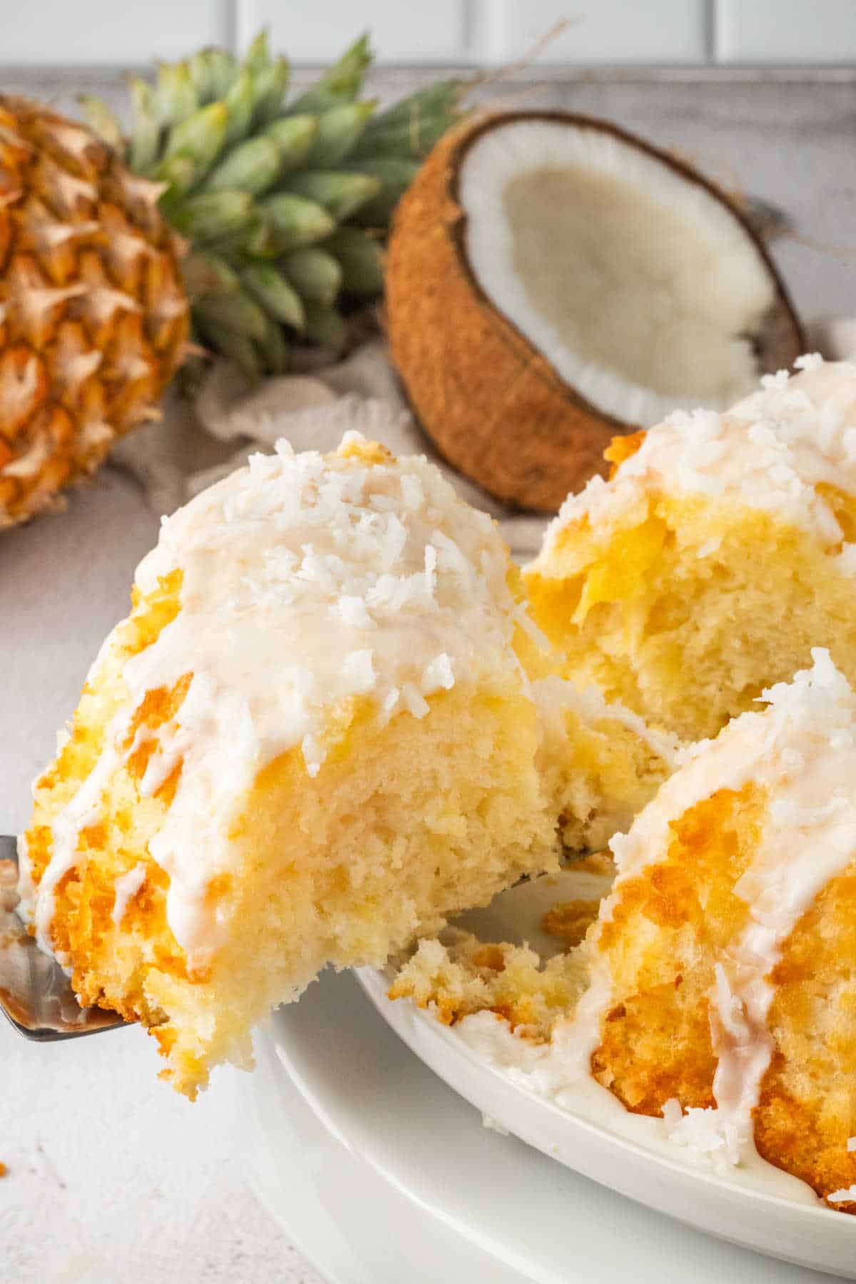 A piece of pineapple coconut bundt cake on a spatula.