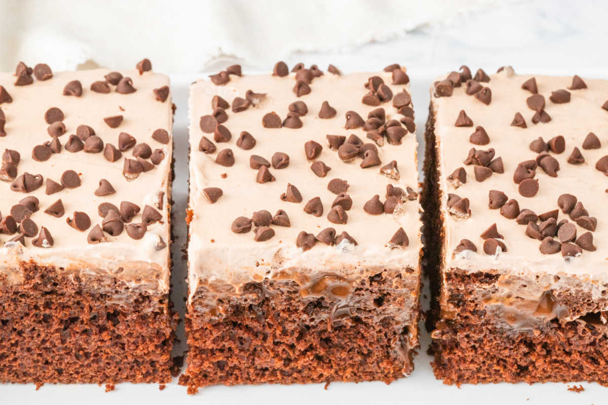 Pieces of triple chocolate poke cake on a platter.