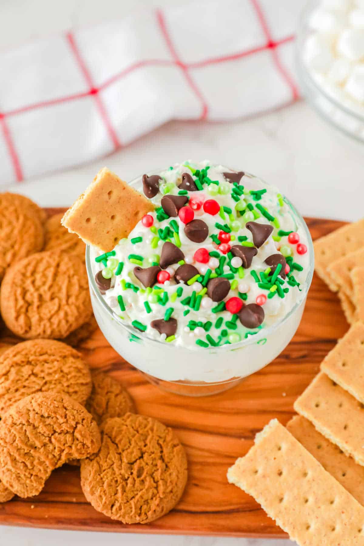 A dish of white chocolate elf fluff surrounded by cookies.