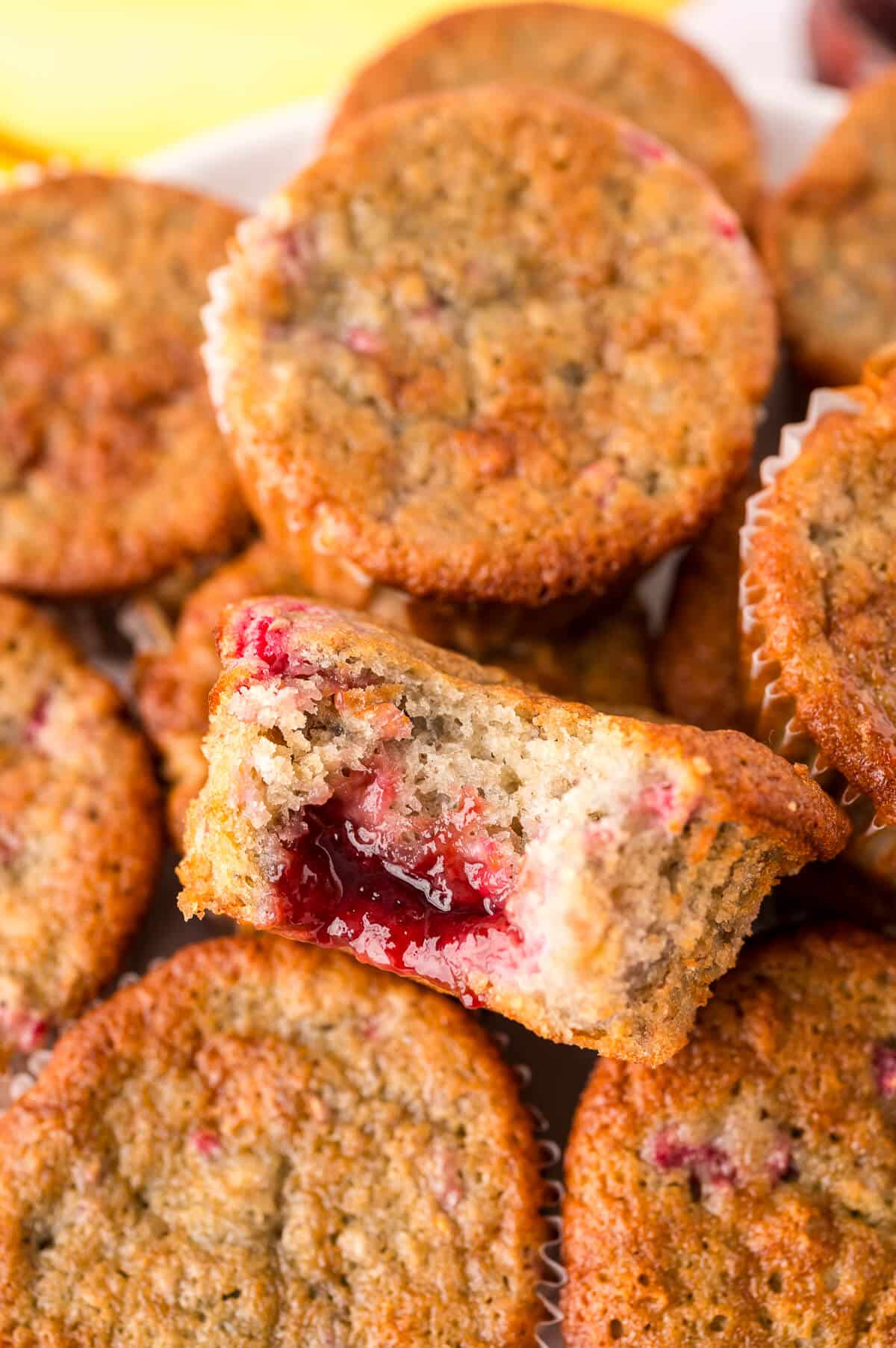 A pile of banana raspberry muffins.