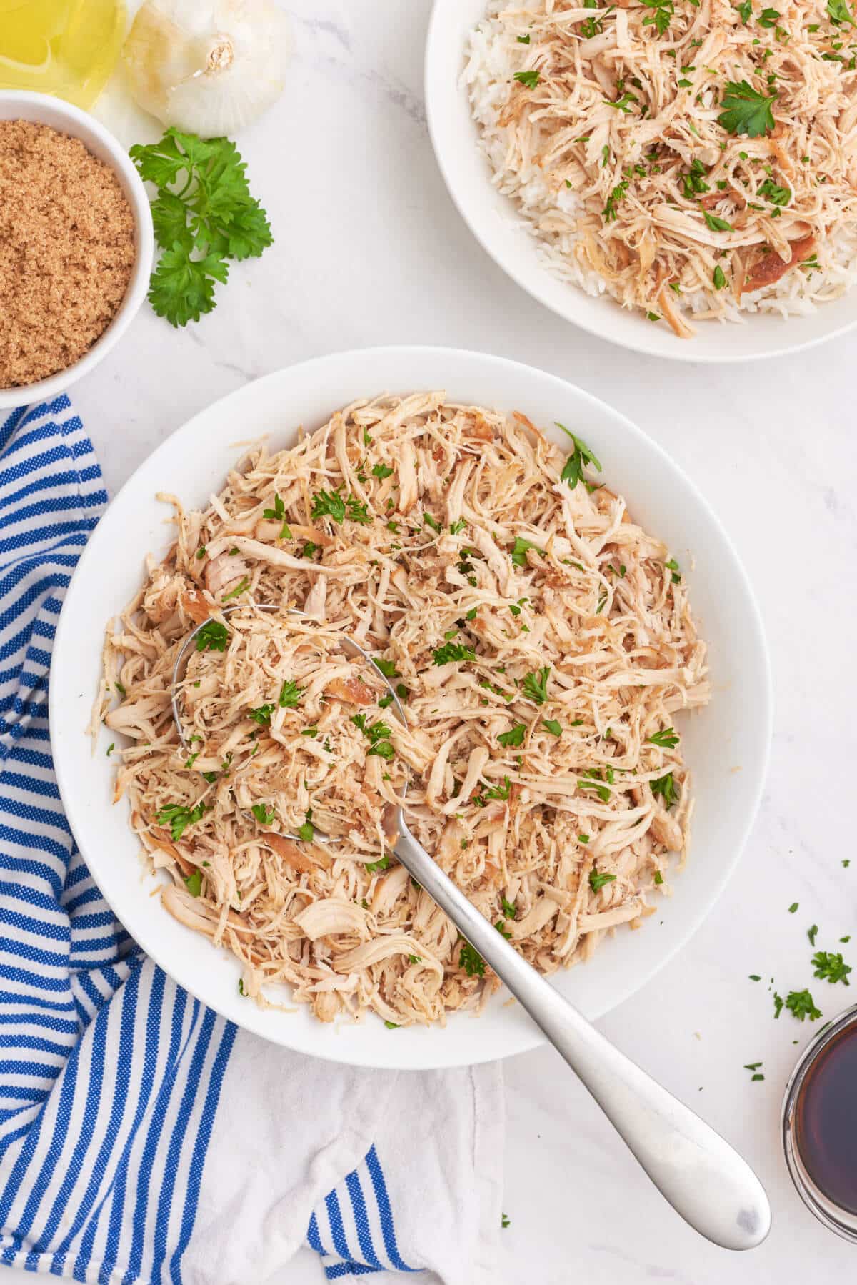 Brown sugar chicken in a bowl with a serving spoon.