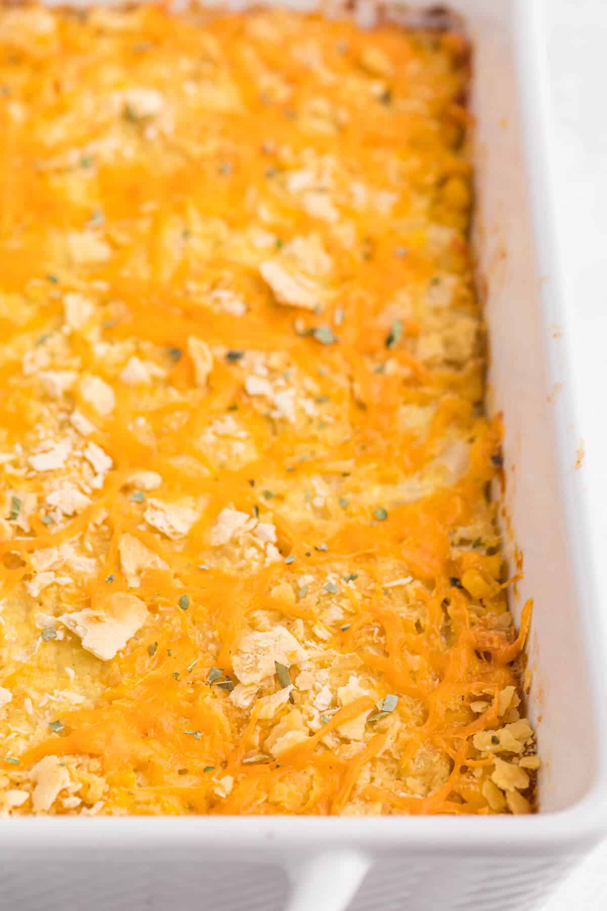 Cheesy corn casserole in a pan.