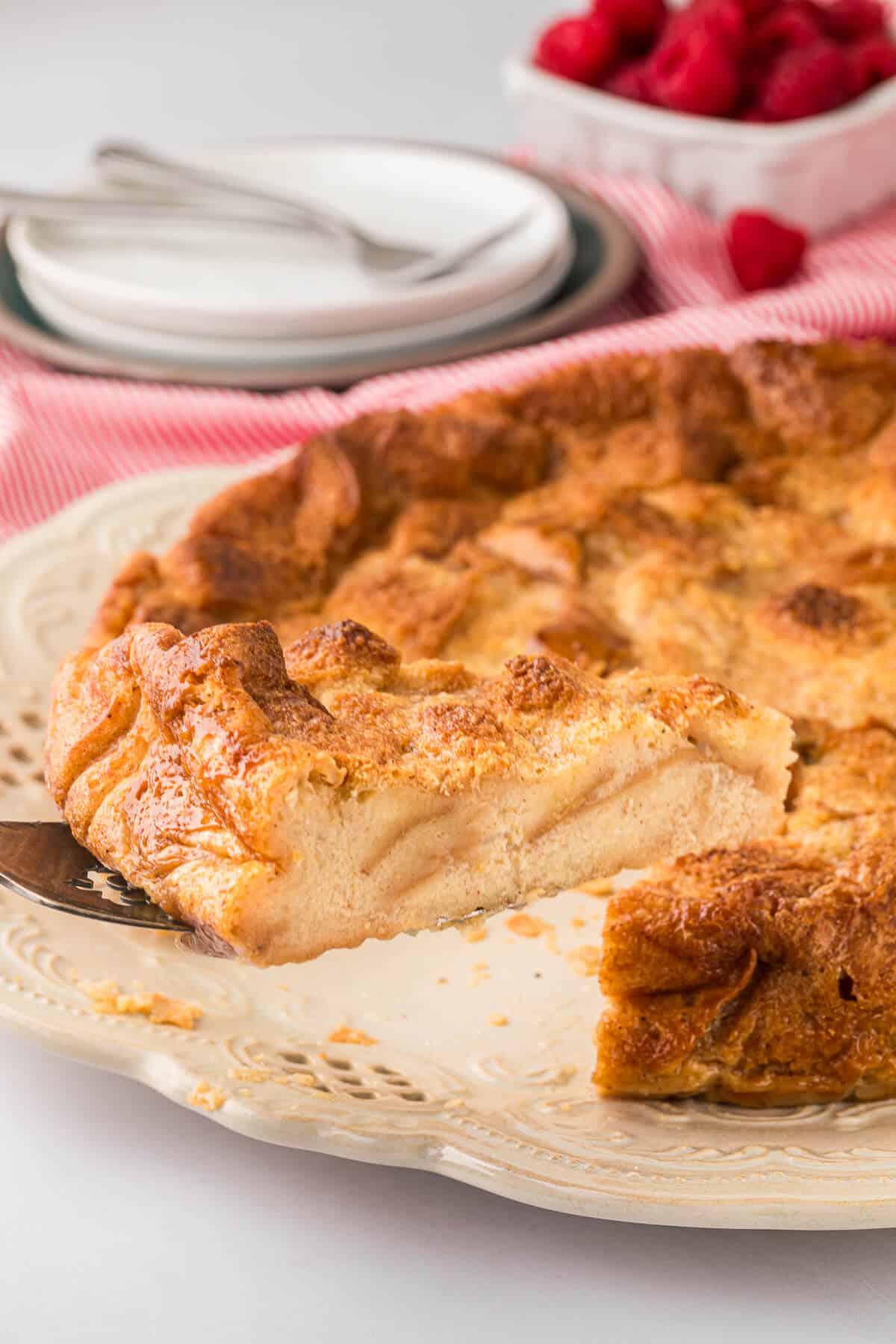 A slice of eggnog bread pudding on a spatula.