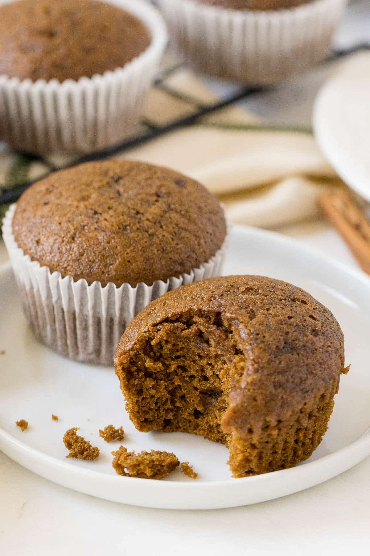 Gingerbread muffin on a plate with a bite out of it.