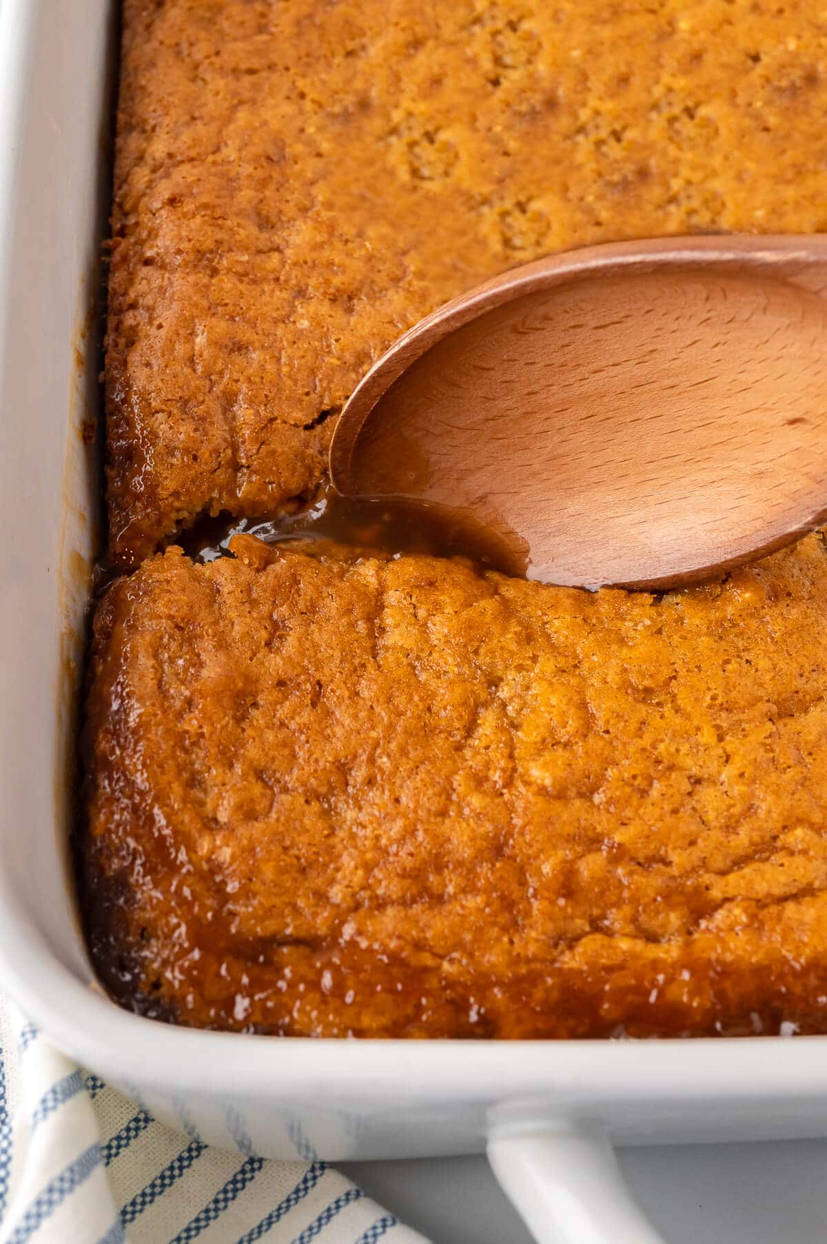 Half hour pudding in a pan with a wooden spoon.
