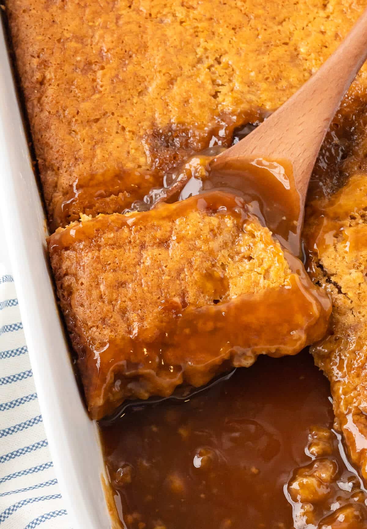 Half hour pudding in a pan with a wooden spoon.