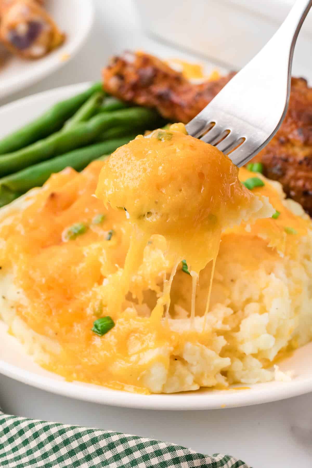 Mashed potato casserole on a plate with a fork.