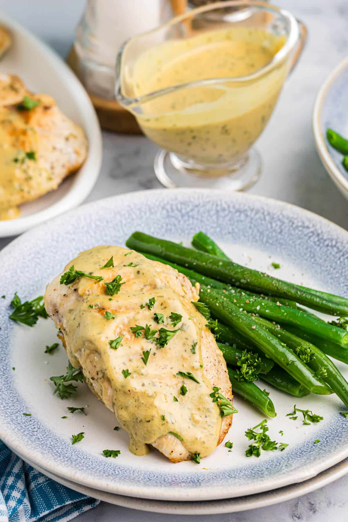 Mustard chicken and green beans on a plate.