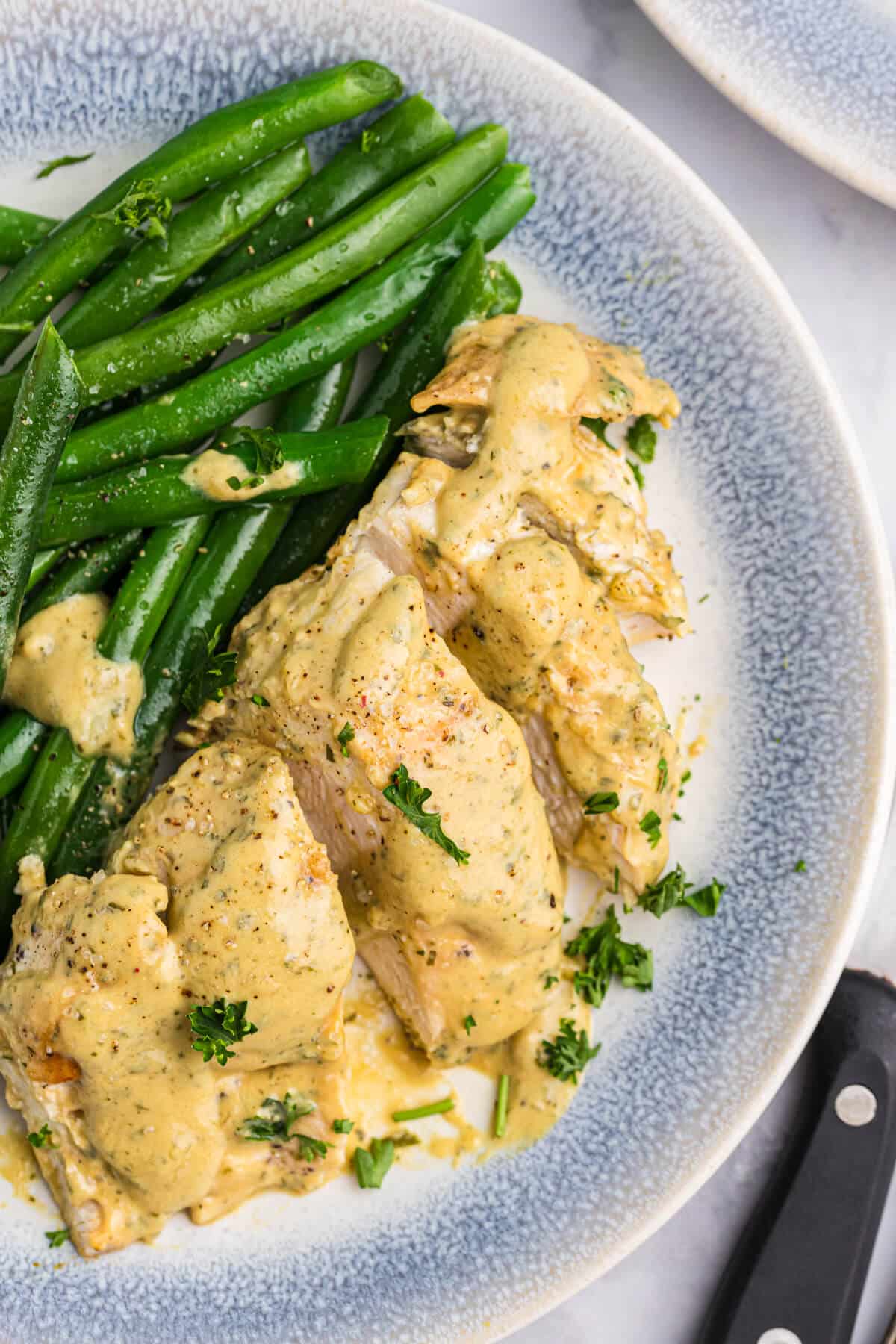 Chicken and green beans on a plate.