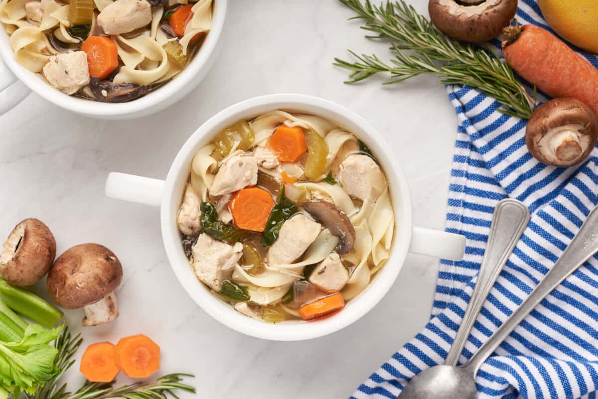 A bowl of rosemary chicken noodle soup.