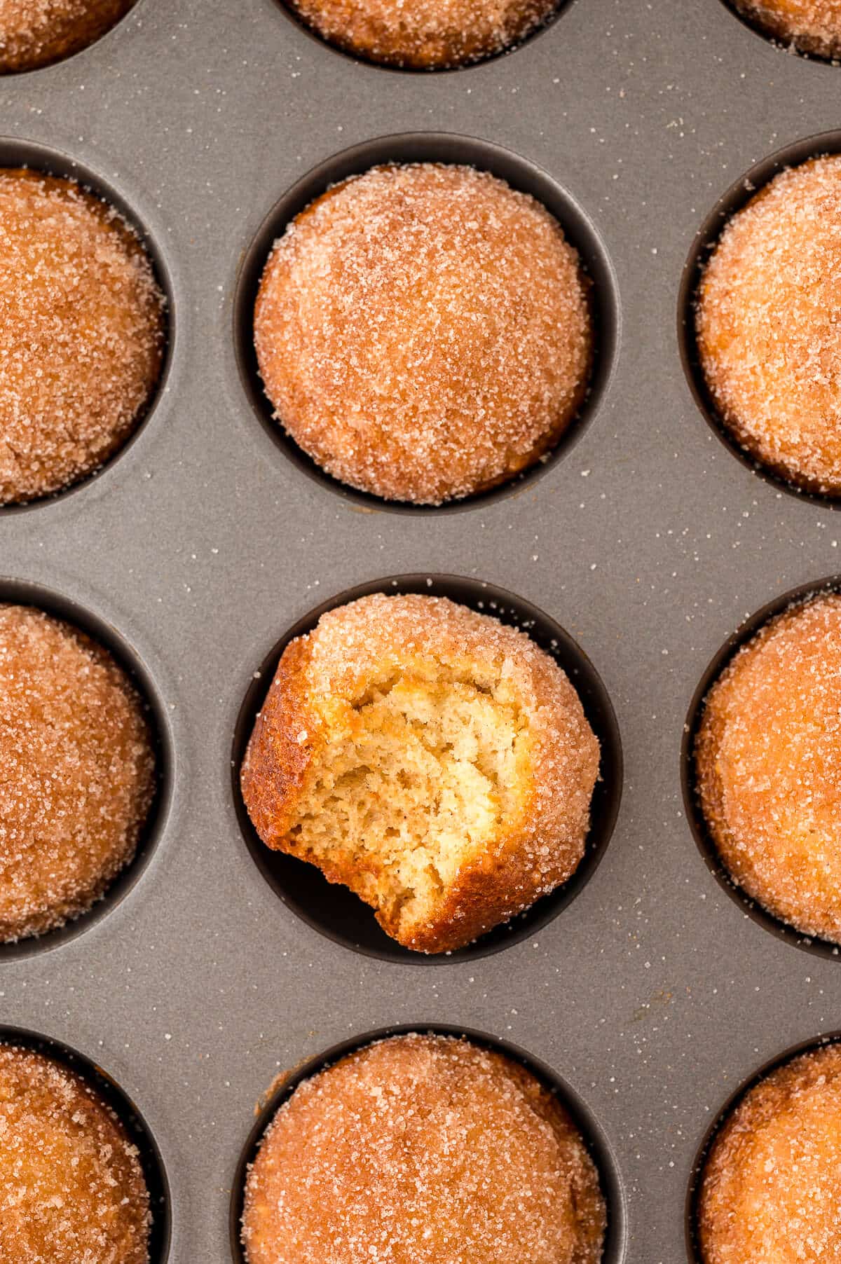 Sugar and spice muffins in a muffin pan.
