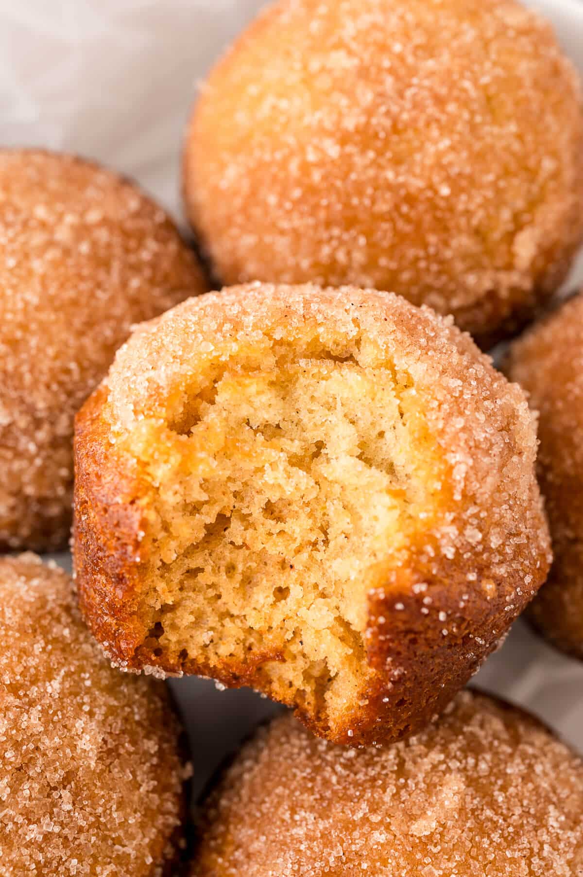 A sugar and spice muffin with a bite out of it.