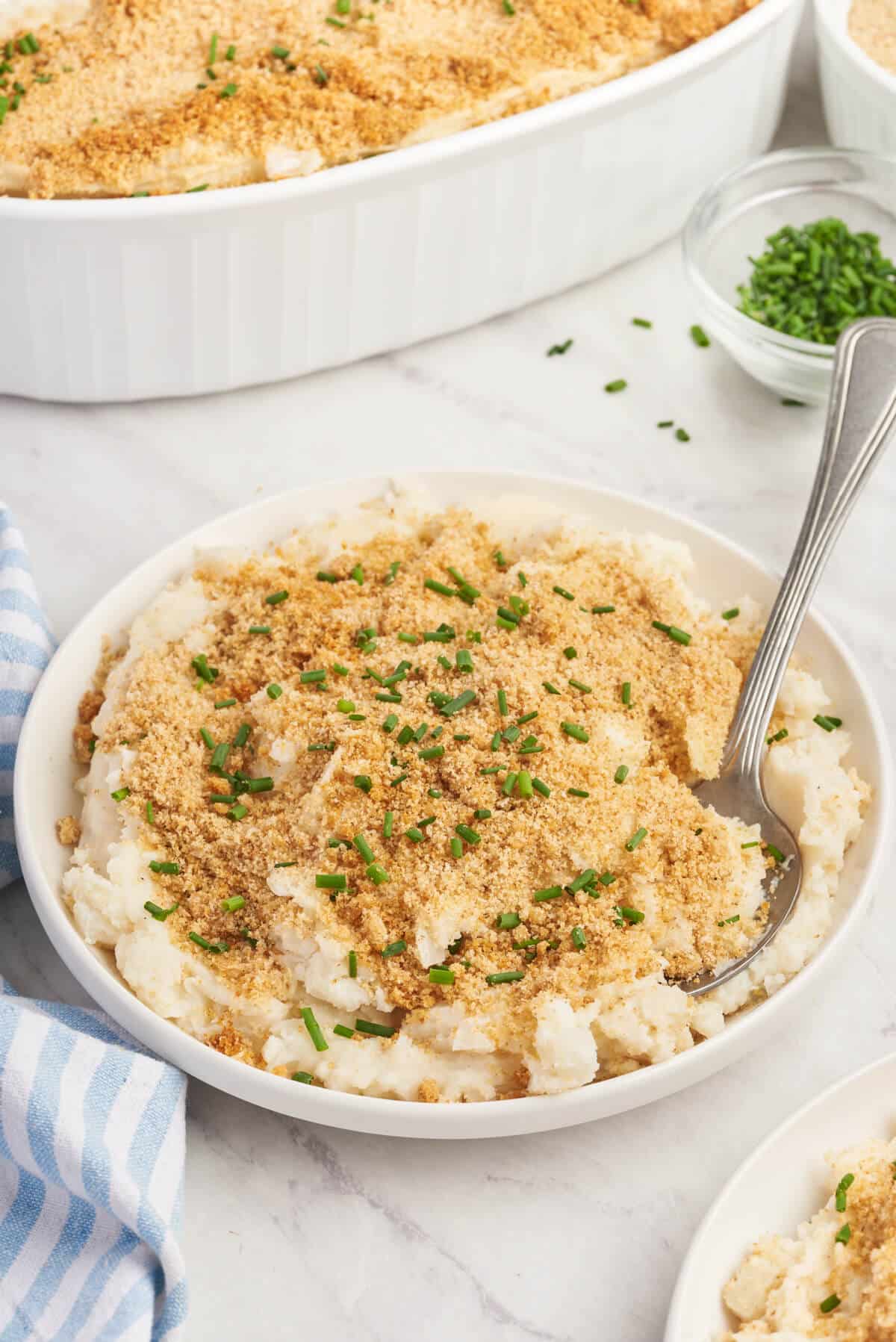 A plate of Swedish Potatoes with a fork.