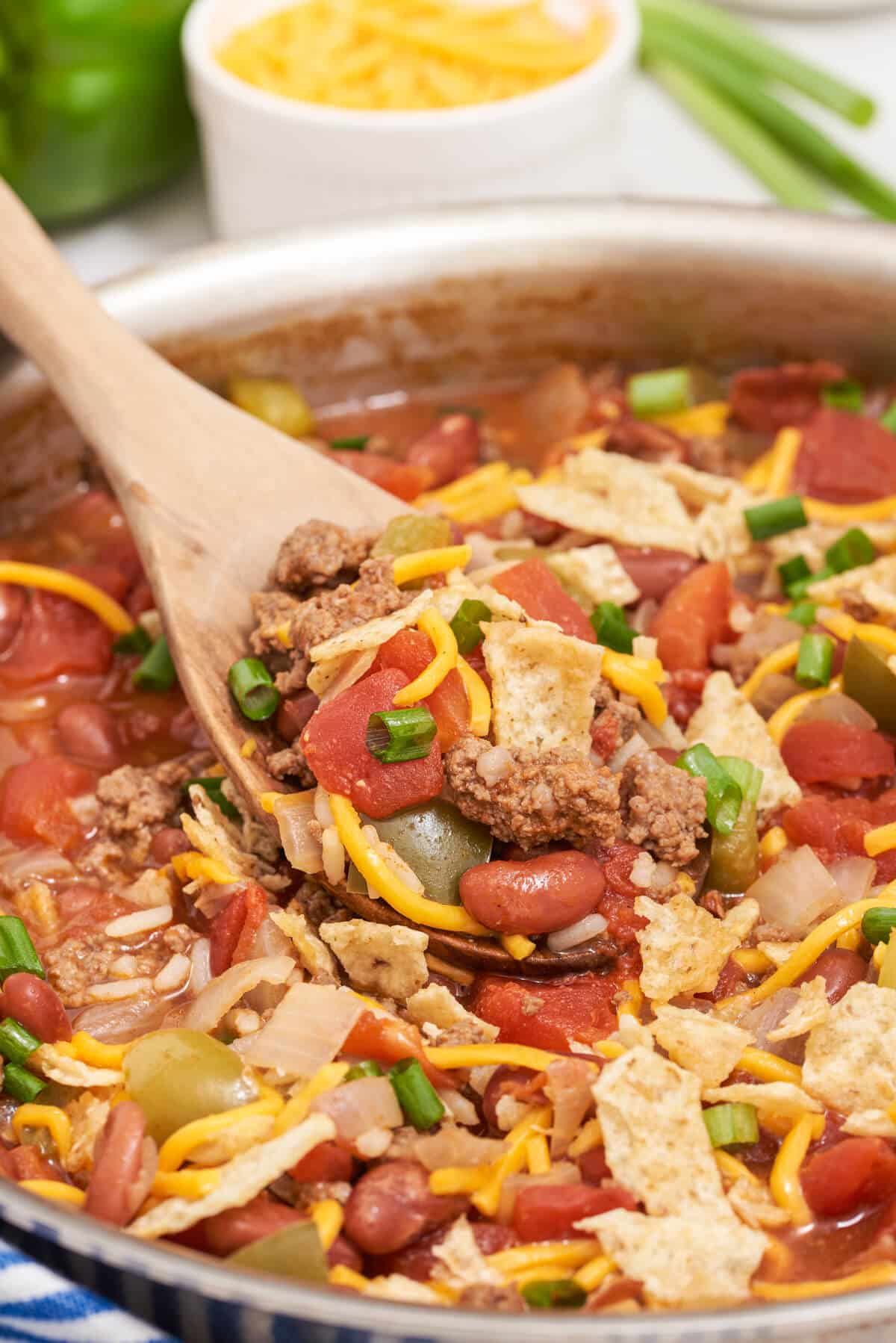 Texas beef skillet in a pan with a wooden serving spoon.