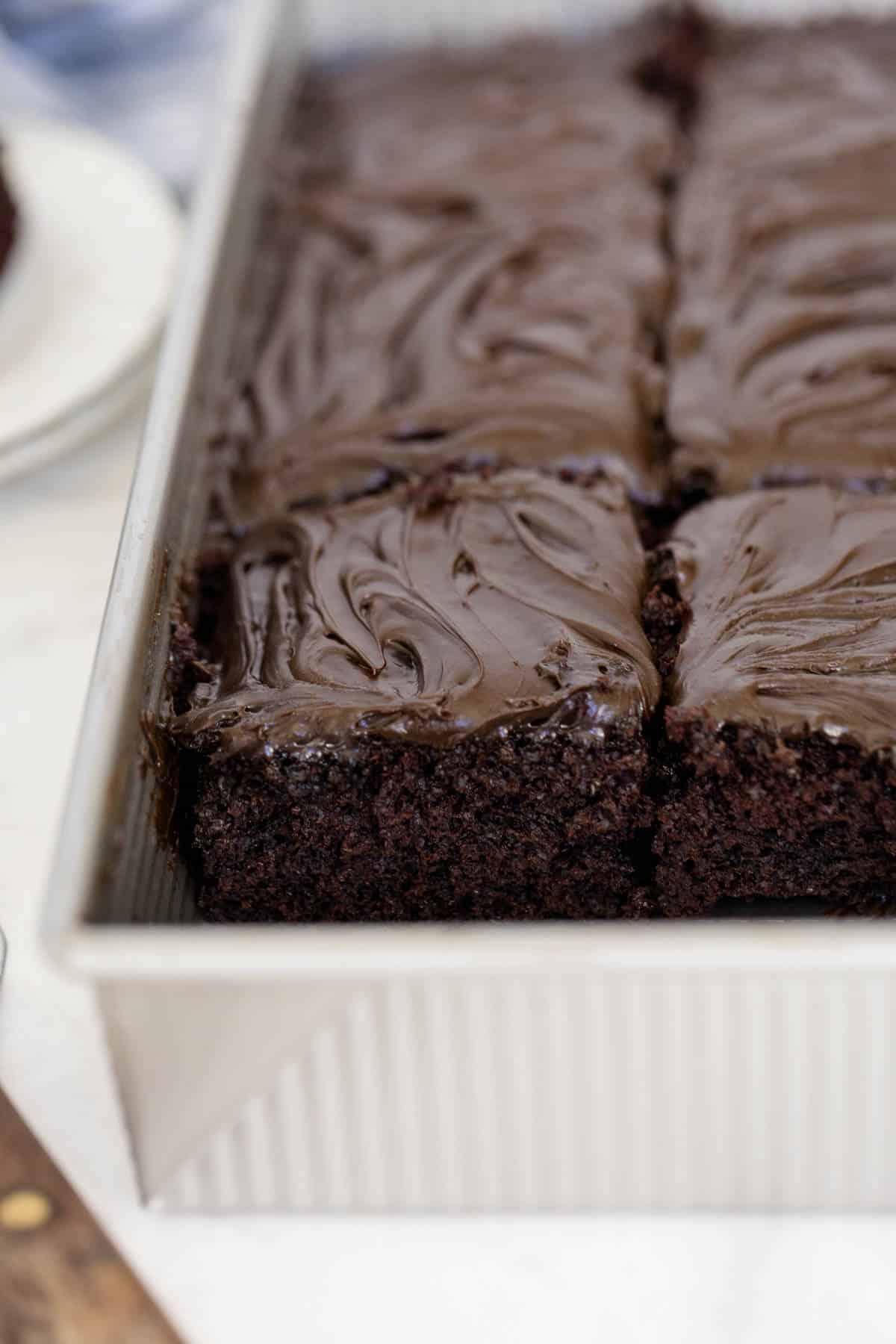 Wacky cake in a pan with slice marks.