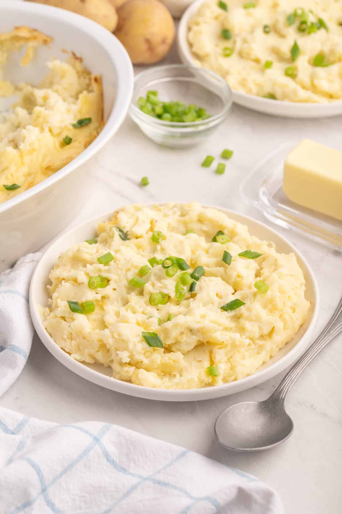 A plate of potatoes on a white counter.