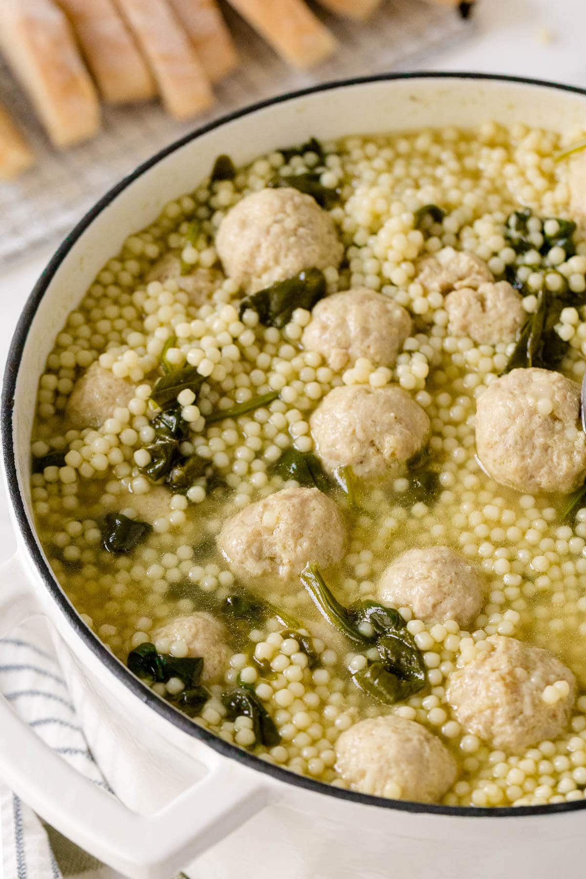 Italian meatball soup in a pot.