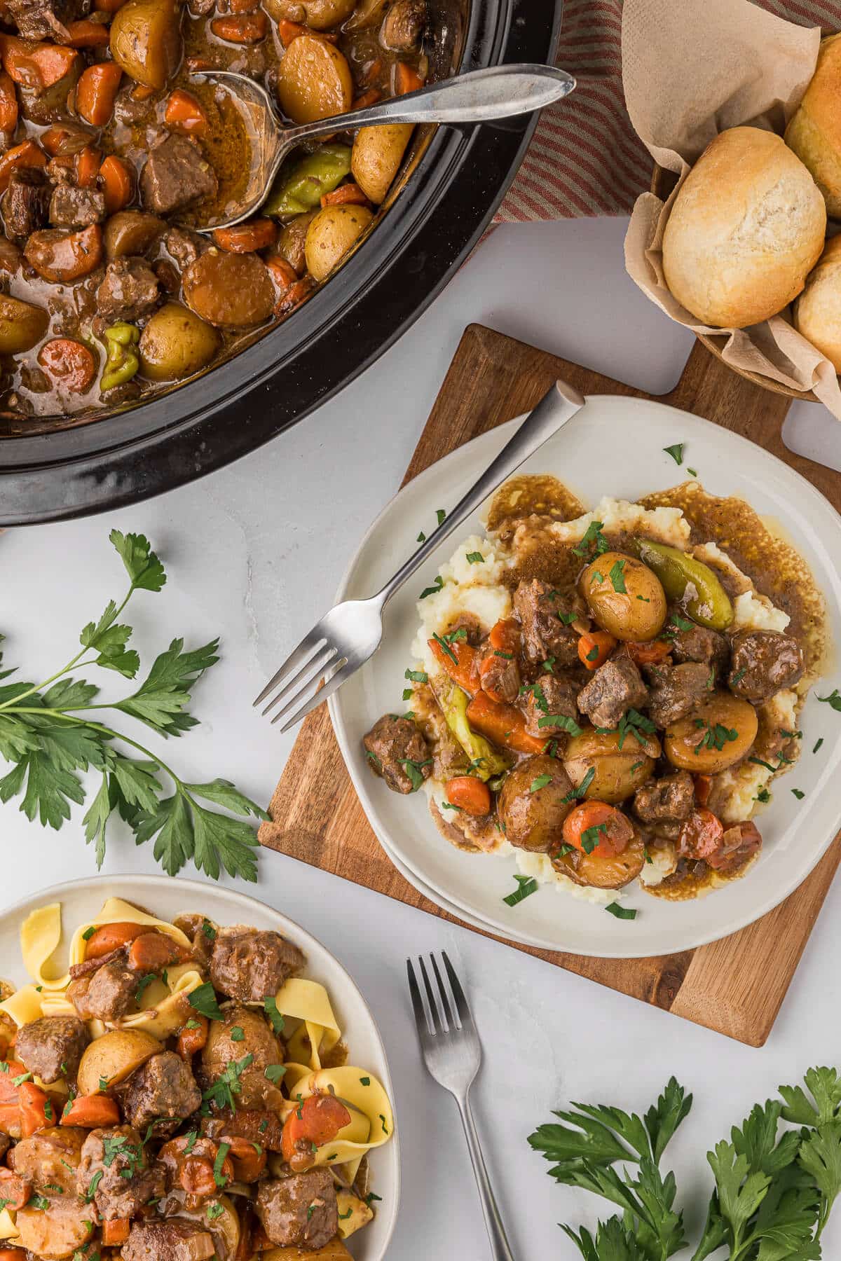 A plate of mashed potatoes with beef stew.