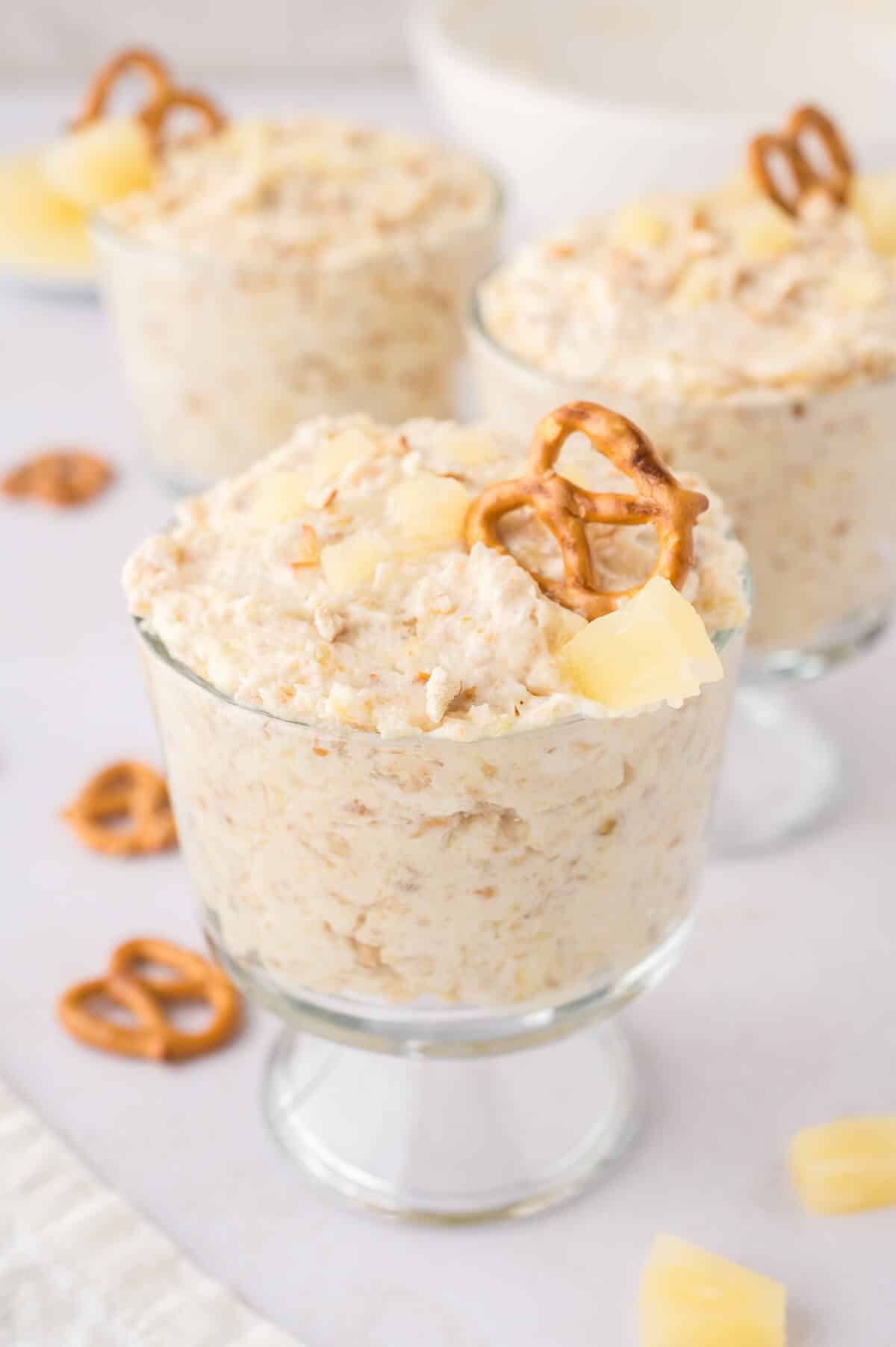 Pineapple pretzel fluff in a parfait dish.