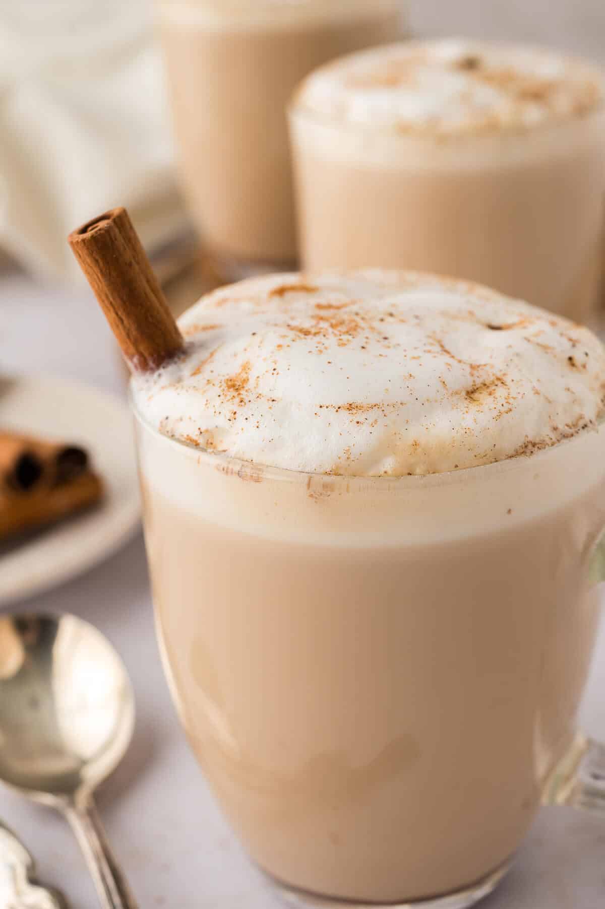 Slow cooker chai latte in a glass mug.