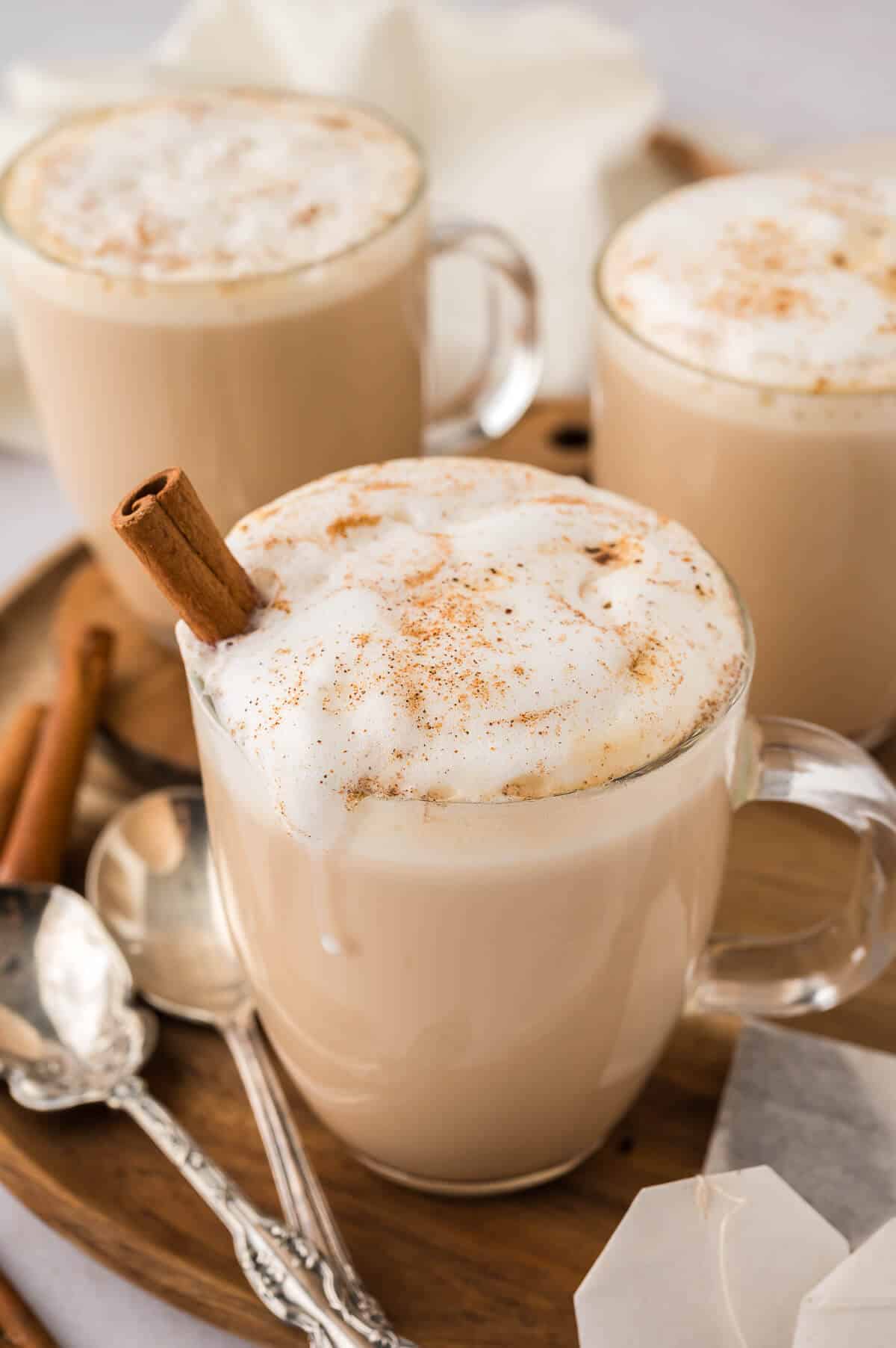 Slow cooker chai latte in a glass mug.